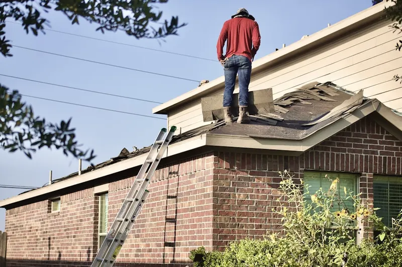 Professional roofer working on a residential roof in Houserville